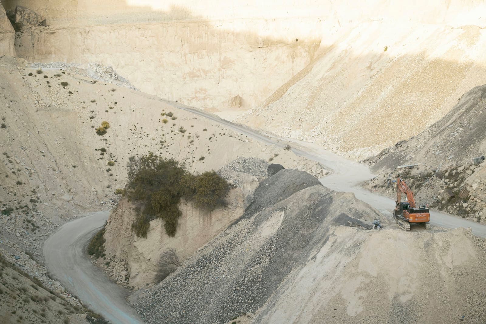 Working limestone quarry with excavator